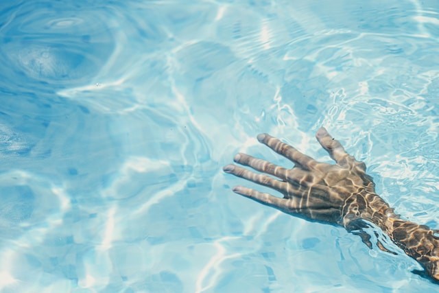 hand in pool under the water