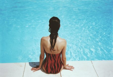 person in red bikini sitting on the pool
